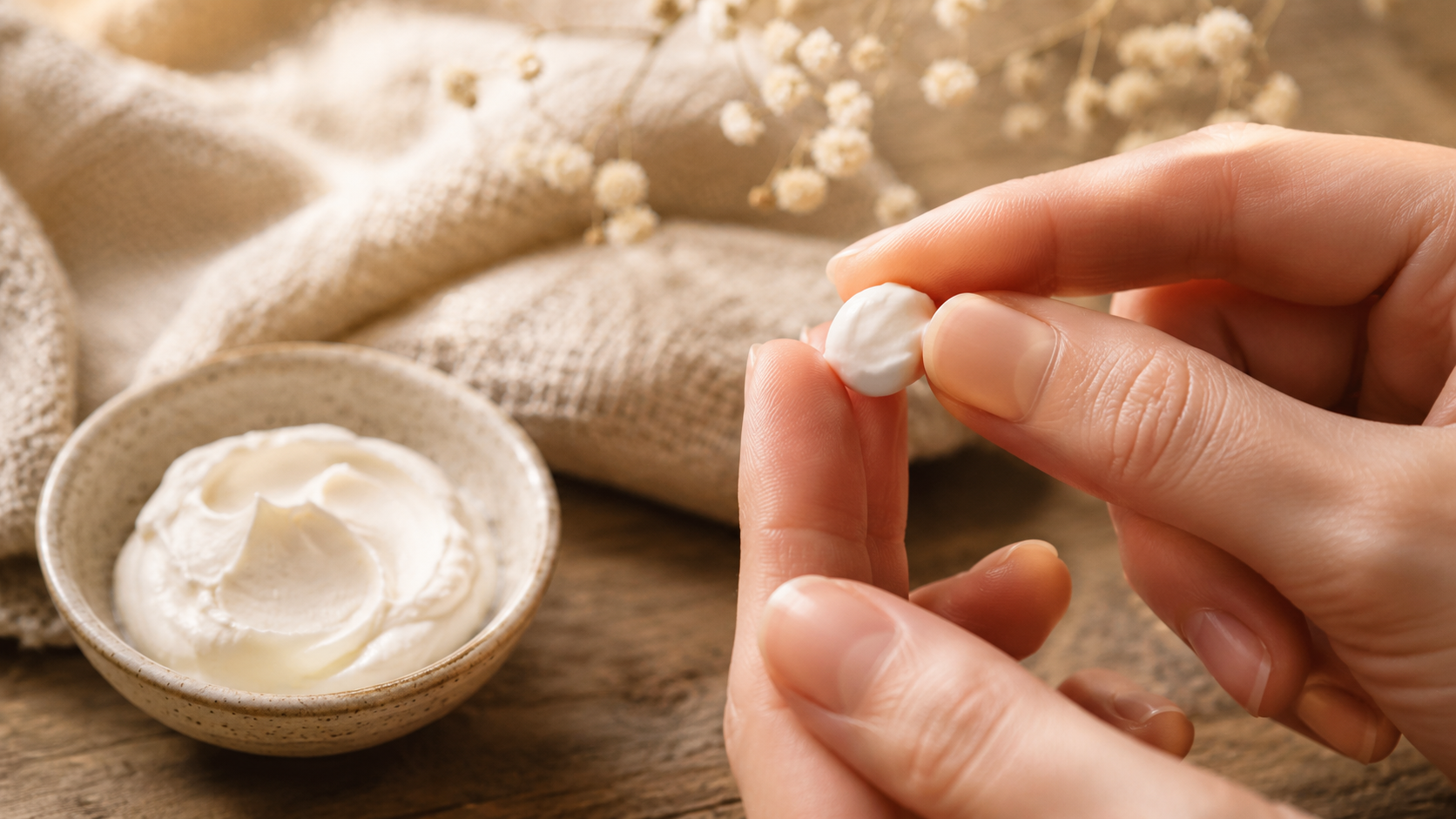 Pea-sized amount of tallow cream held between fingers.